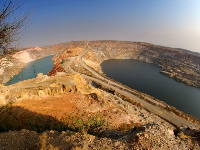 Open-pit copper mine terraces at golden hour